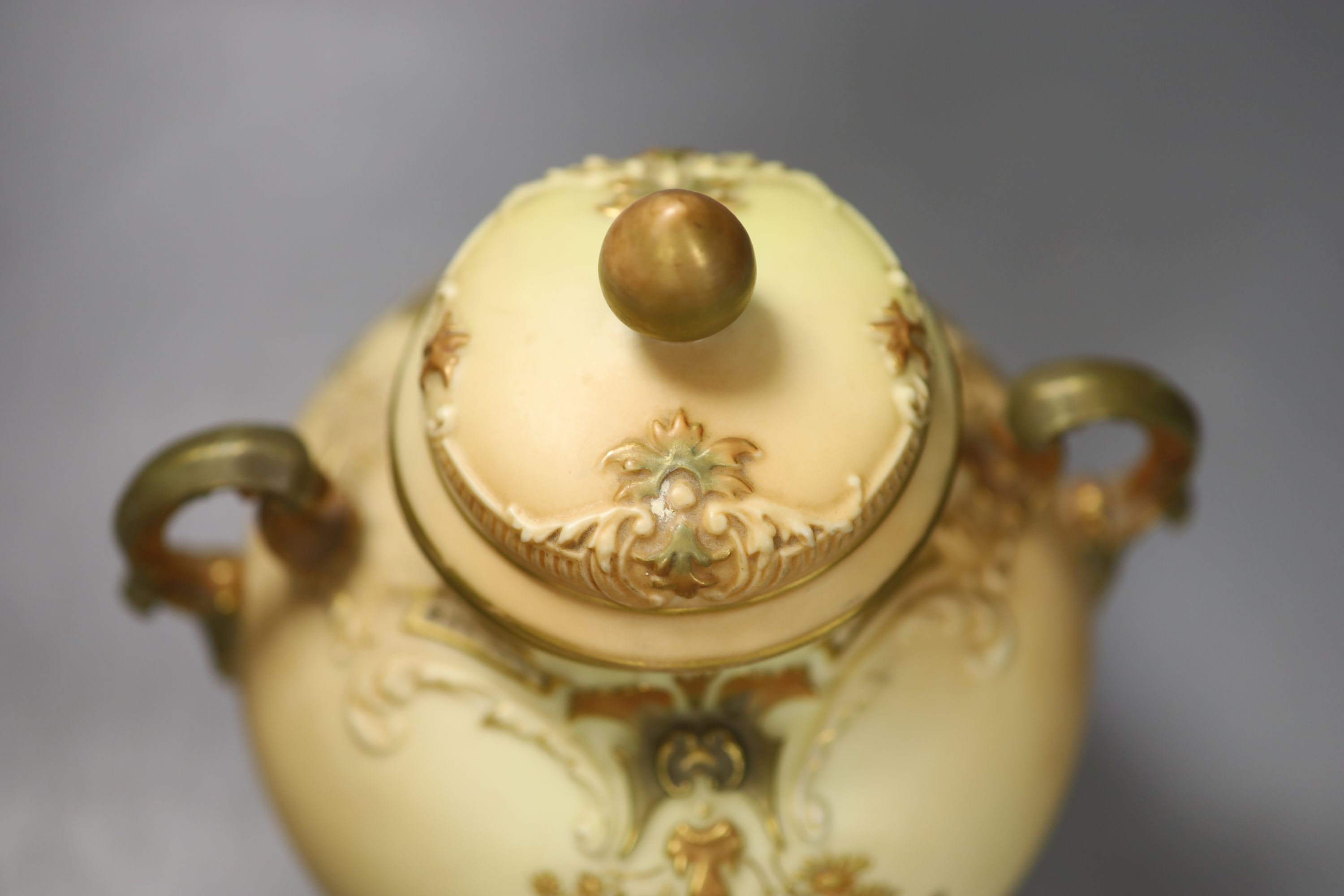 A Royal Worcester two handled ovoid vase moulded and gilded with flowers on a blush ivory ground, shape 1515 date code for 1896, 20cm h